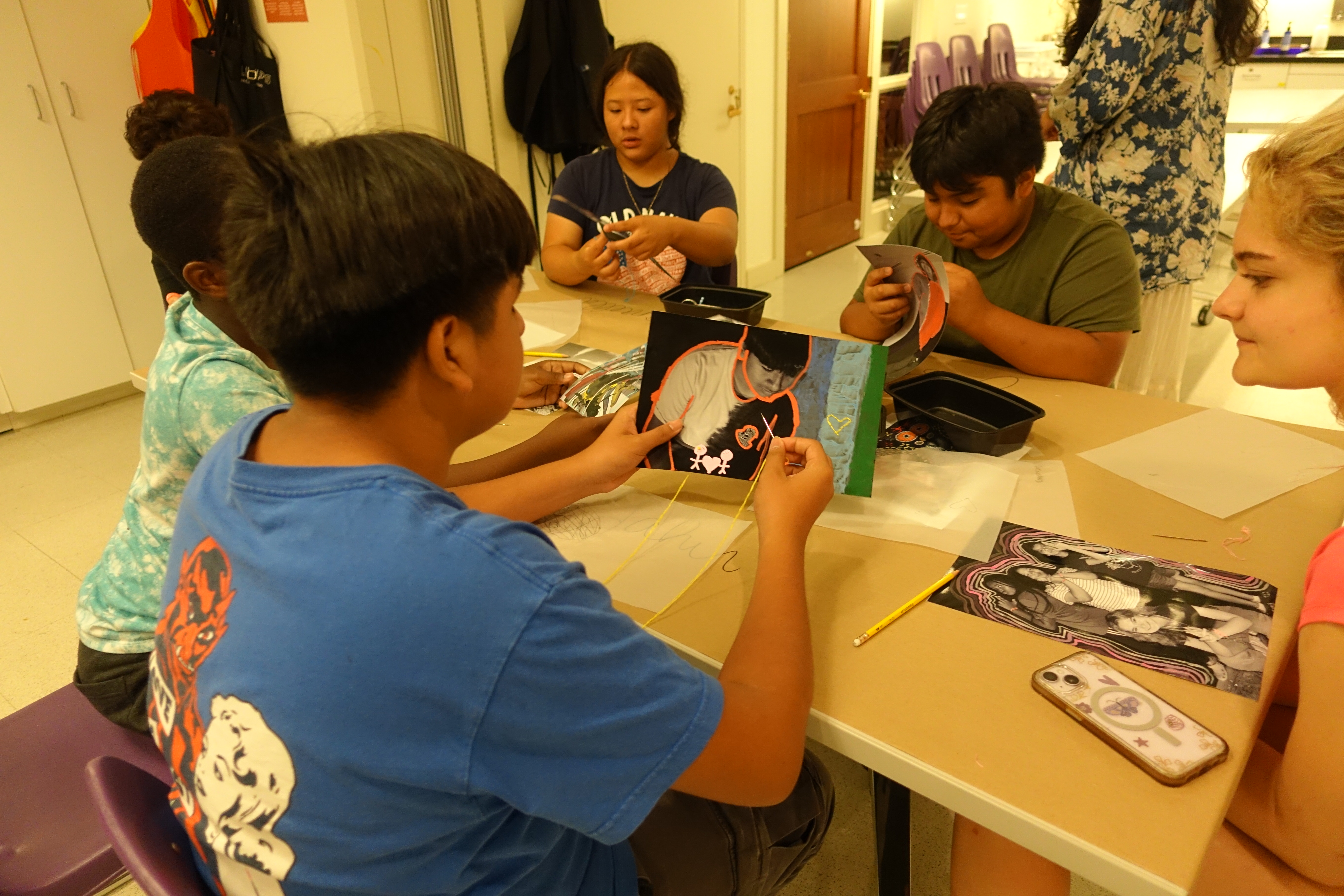 Behind the scenes photo of student threading on photograph